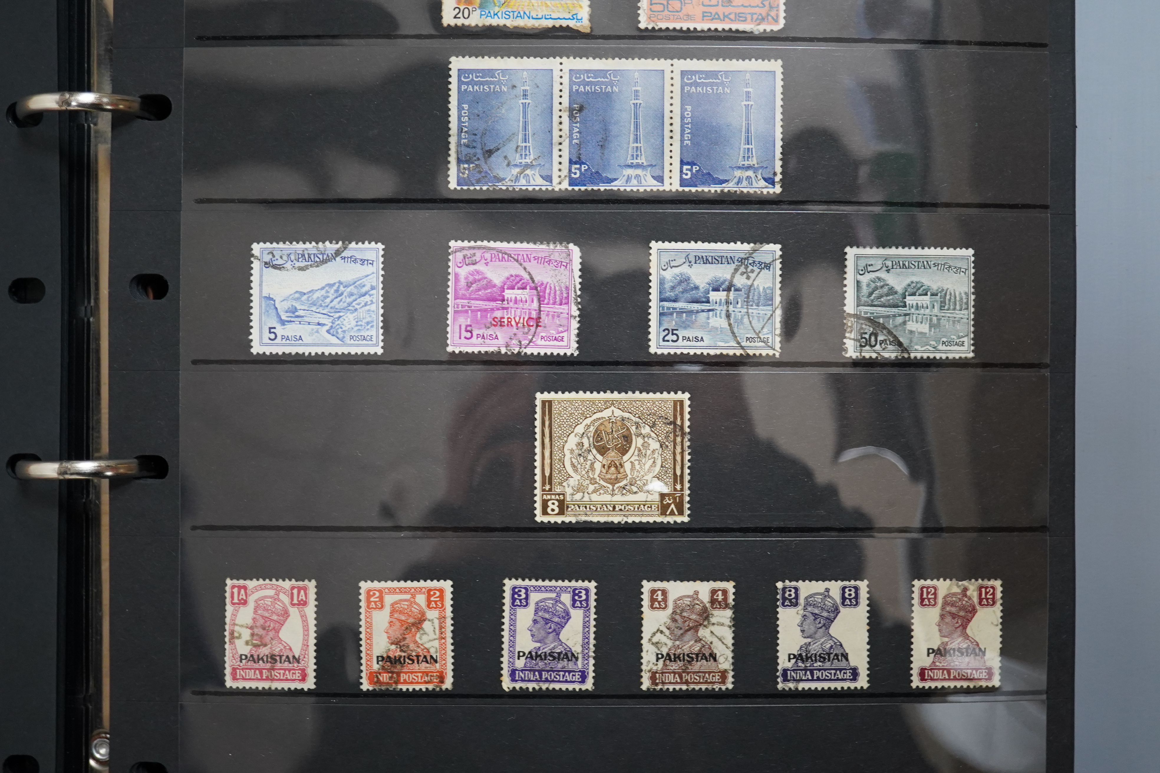 A four albums of mixed stamps, including world and commonwealth, first day covers and an empty album.